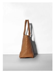 Detailed view of caramel brown woven leather tote bag with sturdy braided top handles
