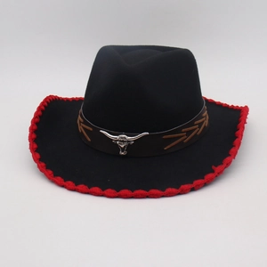 Detail of black felt cowboy hat featuring red crochet edge and silver bull head emblem