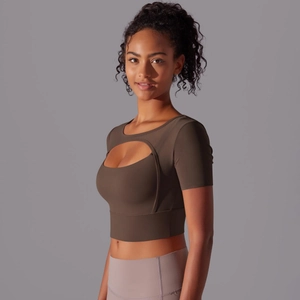 Detail of crop top showing cut-out design and breathable brown yoga fabric