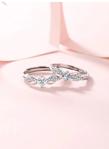 Macro shot of S925 sterling silver couple rings with wing design and zircon stones