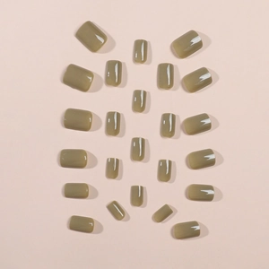 Glossy olive green and khaki short press-on nails set with 24 pieces on beige background