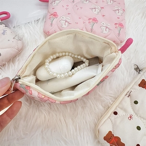 Pink quilted pouch with flower rabbit print showing interior storage and zipper detail