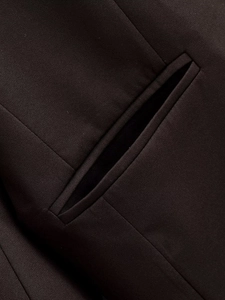 Makro-Detail von dunkelbraunem Blazerstoff mit klassischen Paspeltaschen und Köperbindung