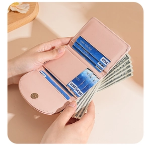 Close-up of pink trifold wallet interior showing multiple card slots and cash compartments