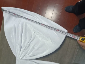 Measurement of a large white velvet fabric butterfly decoration showing 50cm width on wood floor