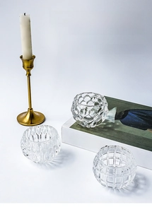 Detailed view of spherical crystal glass candle holders with textured honeycomb patterns
