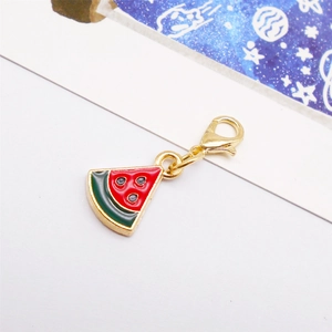 Macro detail of a watermelon enamel pendant with gold lobster clasp for jewelry making