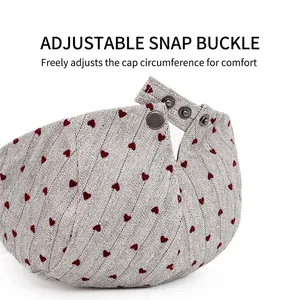 Adjustable gray beret hat with red heart pattern showing retro metal buckle closure