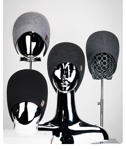 Set of four men's fleece-lined winter knitted beanies displayed on chrome mannequin heads