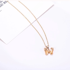 Detailed close-up of butterfly pendant necklace with champagne crystals and gold finish