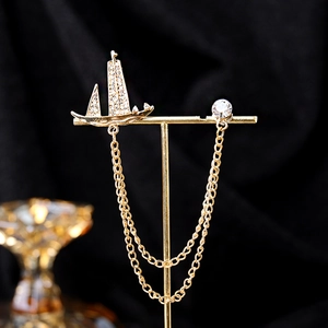 Elegant gold sailboat brooch with rhinestones and double metal chains for suits