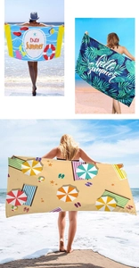 Three vibrant summer beach towels with tropical and starry prints on a sandy shore