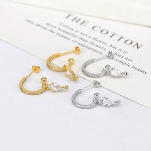 Elegant gold and silver C-shaped drop earrings featuring sparkling pear-cut zircons