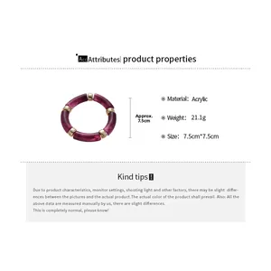 Detailed view of iridescent purple acrylic bangle with golden metal beads and 7.5cm diameter