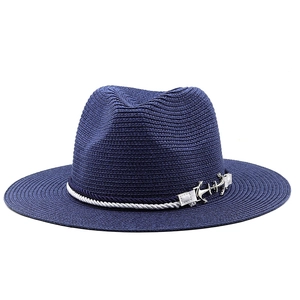 Detail of navy blue panama straw hat featuring white nautical rope and silver anchor charm
