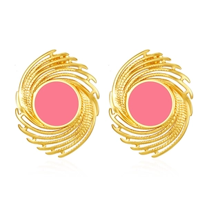 Detail of vintage geometric 18K gold plated earrings with pink enamel swirl patterns