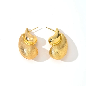 Detail of 14K gold-plated irregular shell earrings with brushed and polished texture