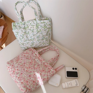 Detail of pink and green floral quilted cotton tote bags with simple wish woven label