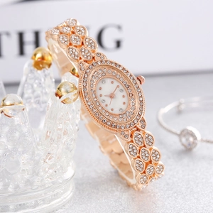 Luxurious rose gold women watch with rhinestone bracelet set displayed on a crown stand
