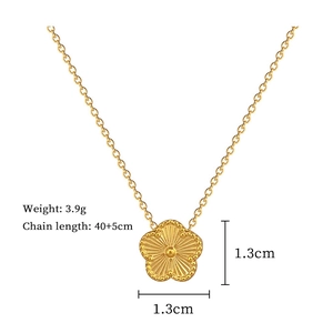 Macro detail of gold flower pendant with laser-cut texture and precise dimensions