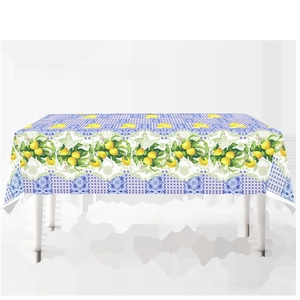 Detail of disposable lemon themed tablecloth with Mediterranean blue and white patterns