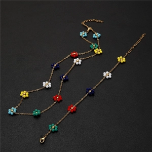 Detail of gold chain with colorful flower beads featuring lobster clasp and extender