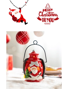 Detail of red vintage Christmas lantern with Santa Claus and mini tree figurines