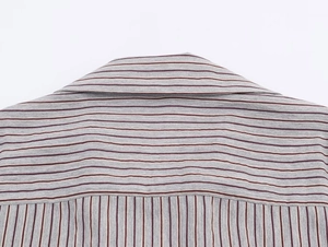 Detail of grey striped shirt showing seam texture and horizontal shoulder yoke