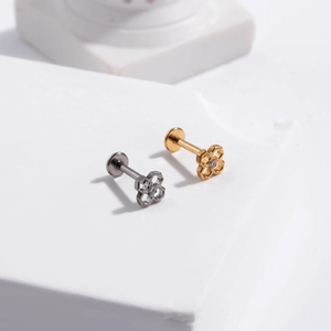 Titanium push-pin flat back studs featuring hollow flower and clover designs on stone pedestal