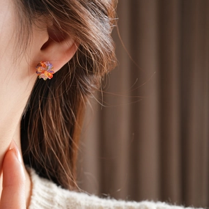 Close-up of a model wearing colorful flower-shaped crystal stud earrings for women