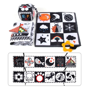 Macro detail of high-contrast black and white fabric book with soft baby sensory toys