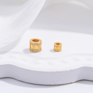 Detailed close-up of S925 silver gold-plated mantra charms with zircon insets for DIY jewelry