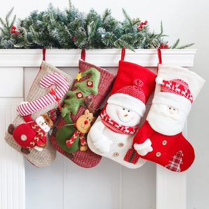 Set of 4 large Christmas stockings with Santa, reindeer and snowman hanging on a mantel