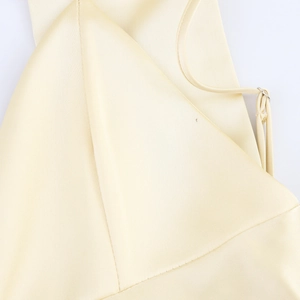 Elegant pale yellow satin slip dress featuring adjustable straps and high-end silk texture
