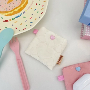 Close-up of heart quilted portable earphone pouch with colorful beads and hanging loop