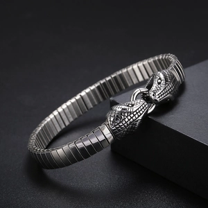 Macro shot of punk double snake head steel bracelet with detailed scale texture