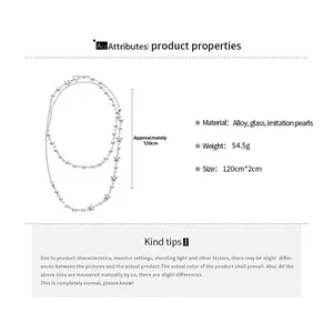 Detail view of multilayer pearl necklace with silver star pendants and alloy chain links