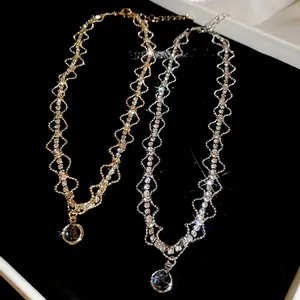 Elegant gold and silver geometric necklaces with sparkling zircon pendants on black velvet