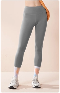 Detailed macro view of the wide high-waisted compression band on gray yoga leggings