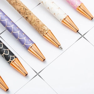 Chic multi-color ballpoint pens with rose gold metal accents on white grid paper