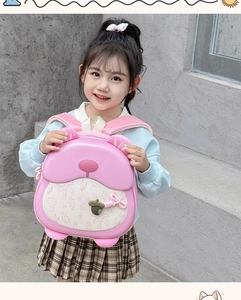 Pink cartoon bear hardshell toddler backpack shown on a child model with floral patterns