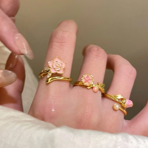 18k gold plated flower ring with pink enamel and crystals worn by a model