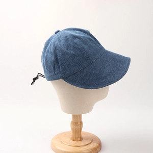Detail of blue denim sun hat featuring adjustable black elastic drawstring on the back