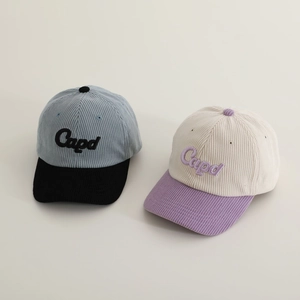 Close-up of corduroy texture on two-tone baseball caps with Capd letter embroidery