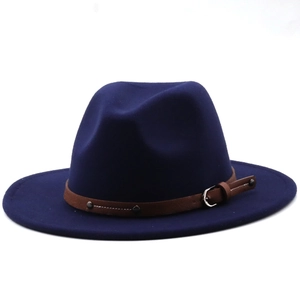 Detail of navy blue wool fedora hat featuring a brown leather band and metal buckle