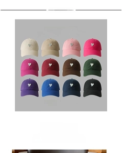 Matrix display of twelve colorful baseball caps featuring minimalist heart embroidery details