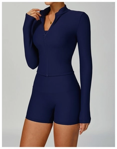 Detail of ribbed texture on navy blue slim-fit yoga jacket with stand collar and zipper