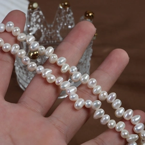 Handheld view of natural white 4-5mm irregular freshwater pearls with natural luster
