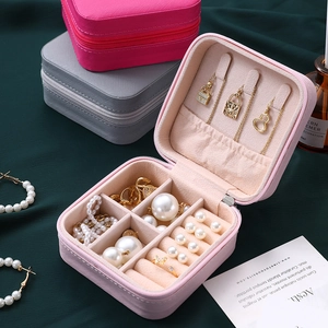 Pink PU leather portable jewelry travel case with zipper closure and velvet compartments