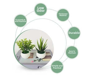 Close-up of artificial succulents in white ribbed pots for office desktop decor